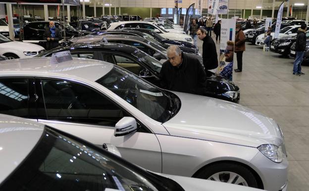 Varios interesados miran algunos de los vehículos que se exponen para su venta en el recinto ferial. /Gabriel Villamil