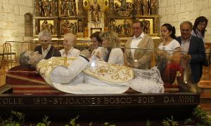 Varias personas observan la urna con los restos de San Juan Bosco. / E. Ruiz/