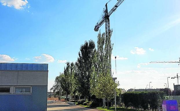 Los padres del colegio El Peral piden que se mueva una grúa que invade el patio al girar