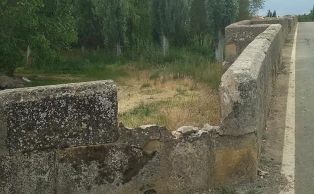 Un tractor rompe a su paso parte del puente romano de Cea